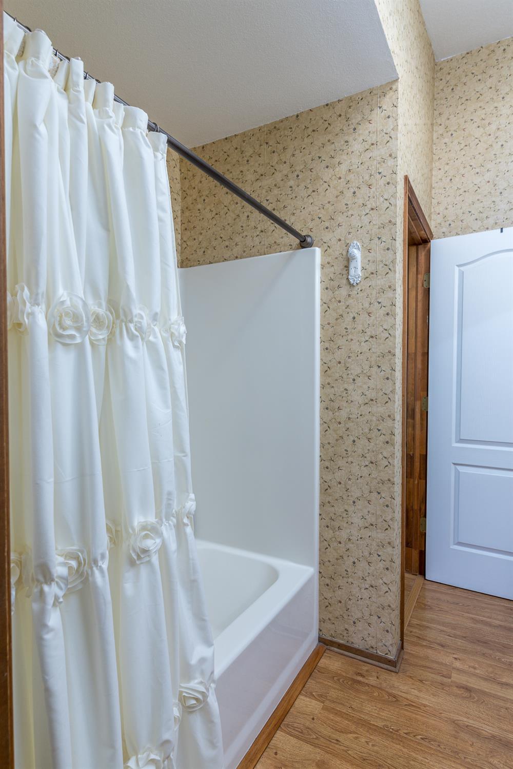2155 El Faro Way La Grange, CA 95329 - Photo 26 of 52 a bathroom with a shower and a tub