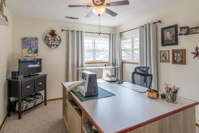 a view of a workspace with furniture