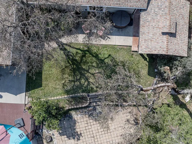 an aerial view of a house with a yard