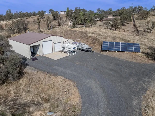 an aerial view of a house with yard