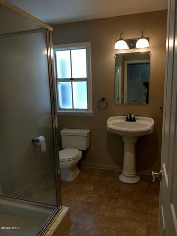 a bathroom with a sink toilet and mirror