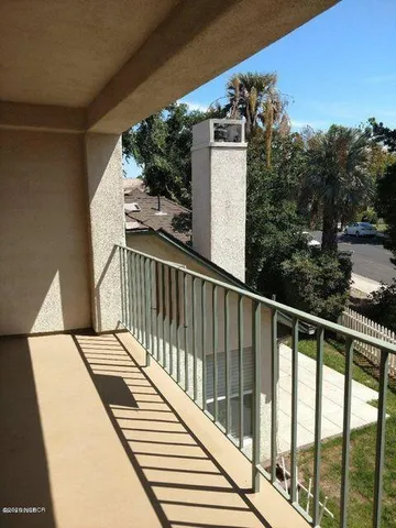 a view of balcony with furniture