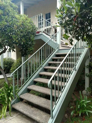 a view of balcony with wooden floor and fence