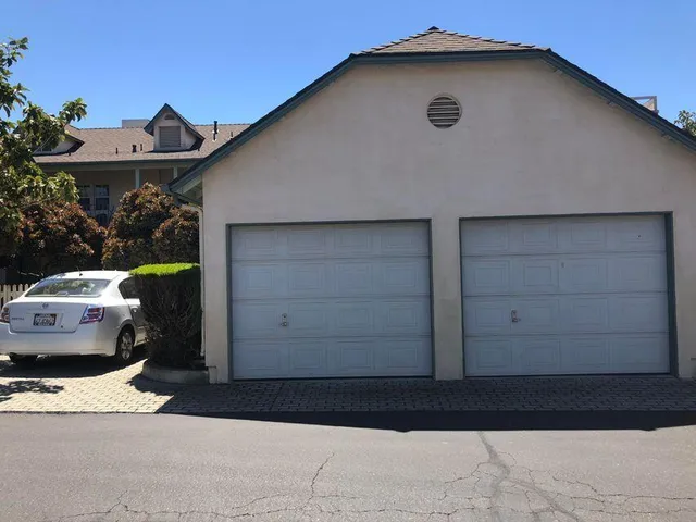 a side view of a house with a garage