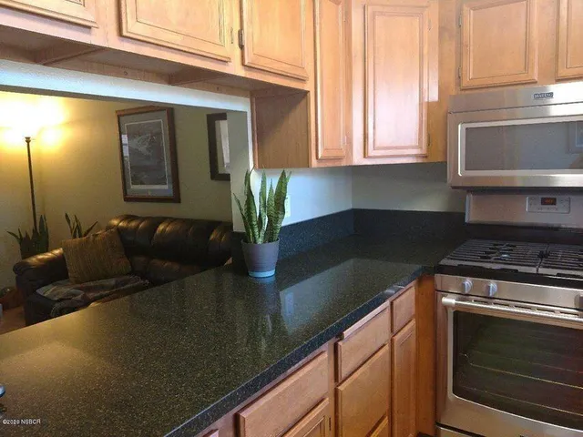 a kitchen with a sink and a stove top oven