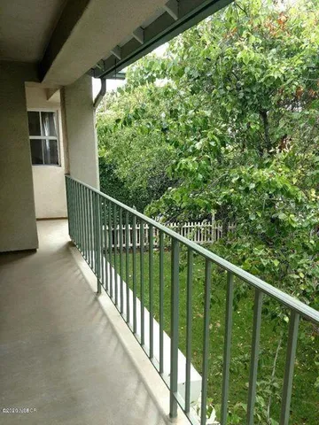 a view of balcony with wooden floor