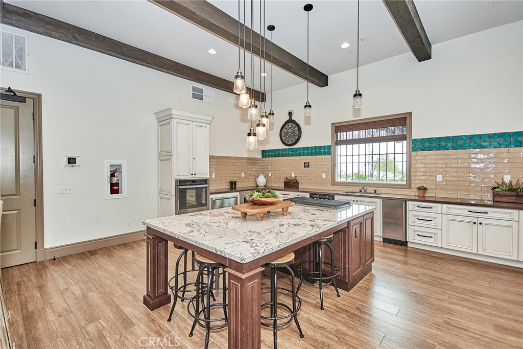 2375 Vineyard Street Upland, CA 91786 - Photo 29 of 33 a kitchen with stainless steel appliances granite countertop a stove a sink dishwasher and a refrigerator with wooden floor