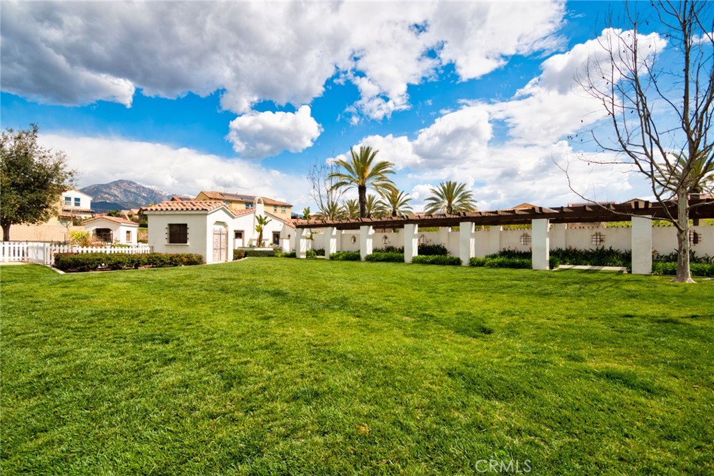 2375 Vineyard Street Upland, CA 91786 - Photo 31 of 33 a view of a white house with a big yard and large trees