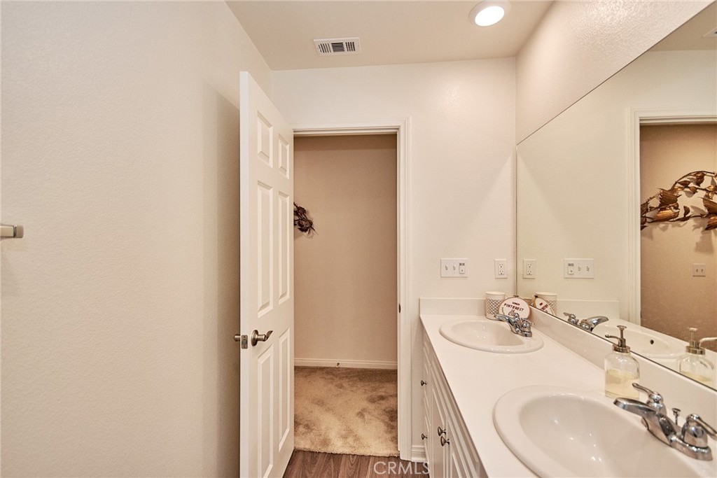 2375 Vineyard Street Upland, CA 91786 - Photo 9 of 33 a bathroom with a sink a mirror and a shower