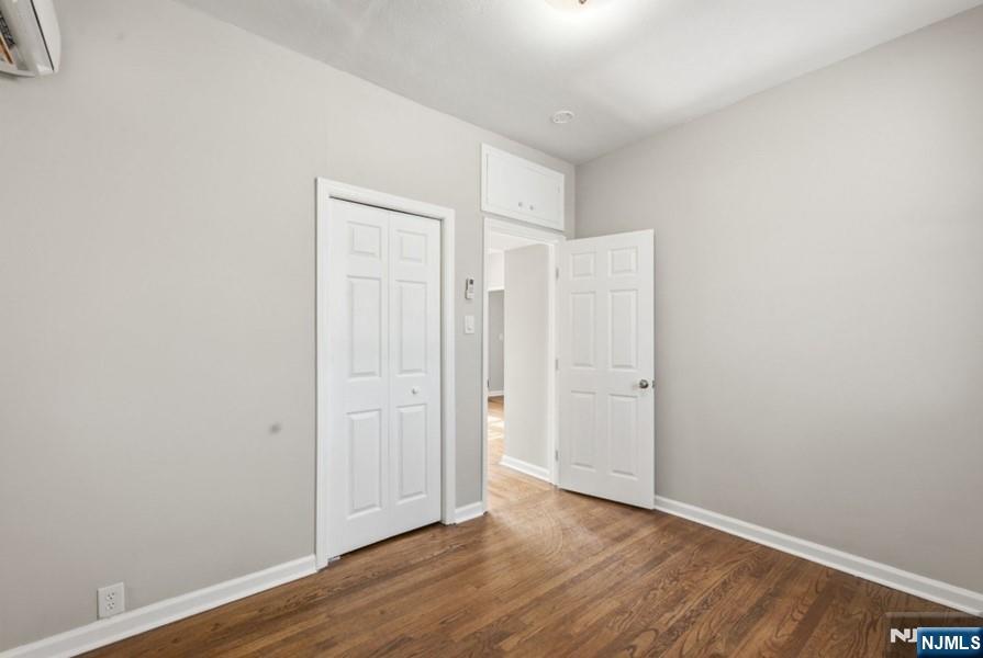 693 North 8th Street Newark, NJ 07107 - Photo 11 of 23 an empty room with wooden floor & closet area