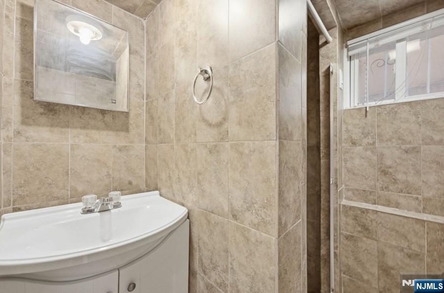 693 North 8th Street Newark, NJ 07107 - Photo 17 of 23 a bathroom with a sink and a mirror