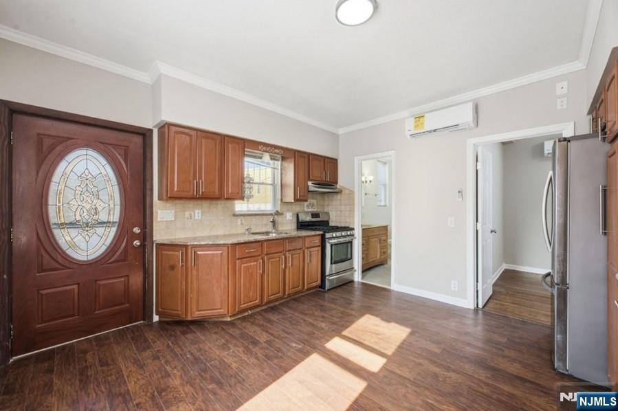 693 North 8th Street Newark, NJ 07107 - Photo 3 of 23 a large kitchen with cabinets wooden floor and a refrigerator
