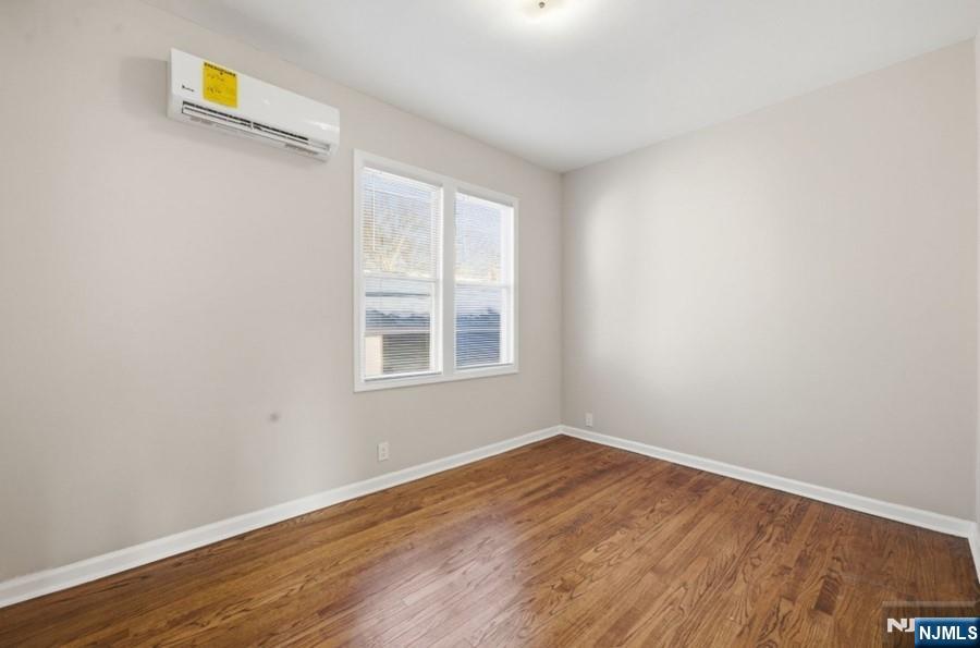693 North 8th Street Newark, NJ 07107 - Photo 6 of 23 an empty room with wooden floor and windows