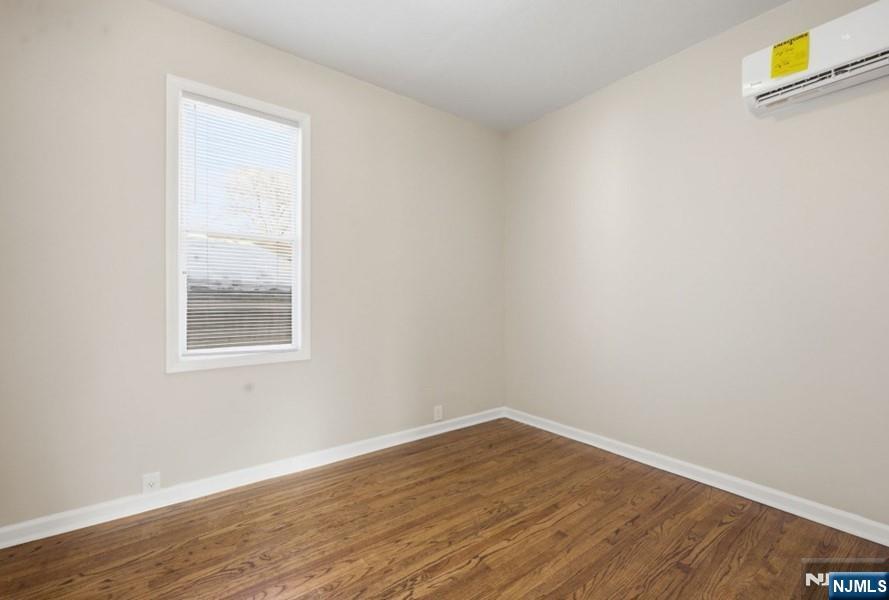 693 North 8th Street Newark, NJ 07107 - Photo 10 of 23 an empty room with wooden floor and windows