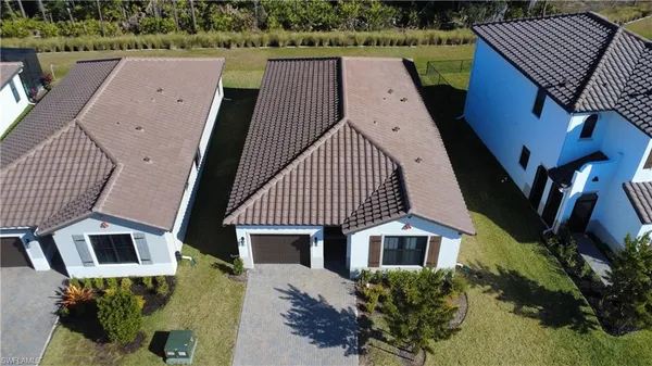 an aerial view of a house with a yard