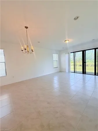 an empty room with a cabinet and mirrors