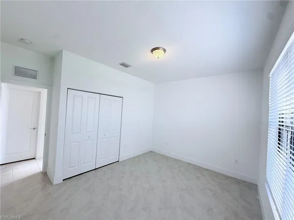 an empty room with a empty space and windows