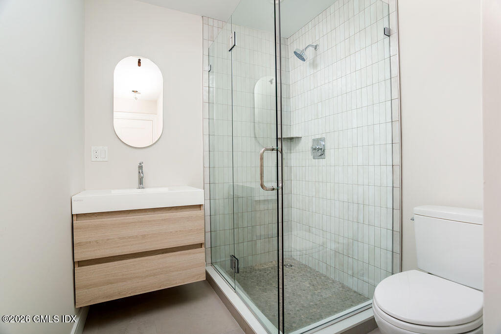 49 Salisbury Road Darien, CT 06820 - Photo 24 of 40 a bathroom with a toilet a sink and shower