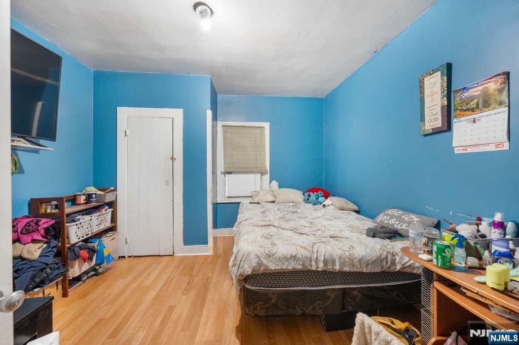 610 Main Street Paterson, NJ 07503 - Photo 15 of 30 a bedroom with a bed and a dresser