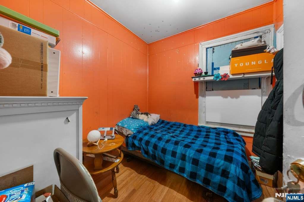 610 Main Street Paterson, NJ 07503 - Photo 5 of 30 a bedroom with a bed and flat screen tv