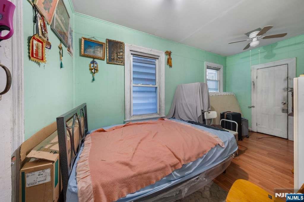 610 Main Street Paterson, NJ 07503 - Photo 6 of 30 a bedroom with a bed and wooden floor