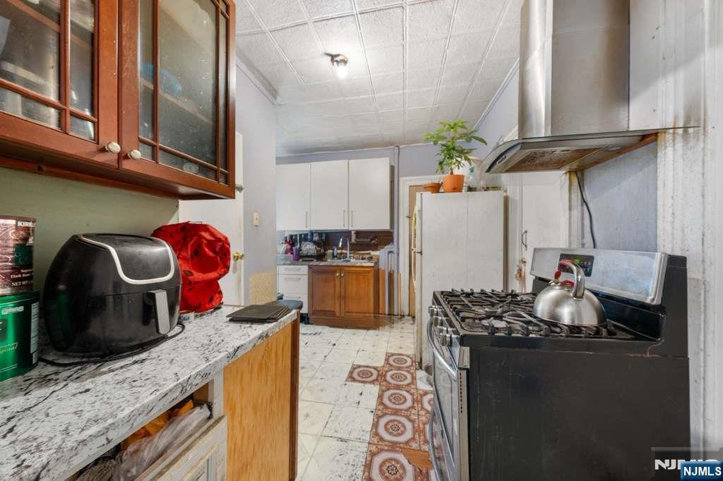 610 Main Street Paterson, NJ 07503 - Photo 7 of 30 a kitchen with stainless steel appliances granite countertop a sink stove and refrigerator