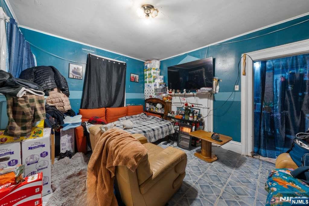 610 Main Street Paterson, NJ 07503 - Photo 9 of 30 a bedroom with furniture and a flat screen tv