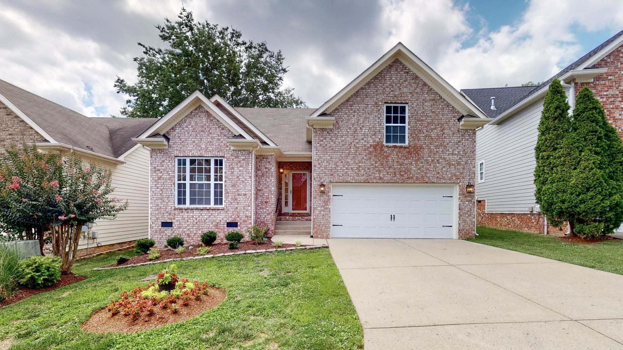 a front view of a house with garden