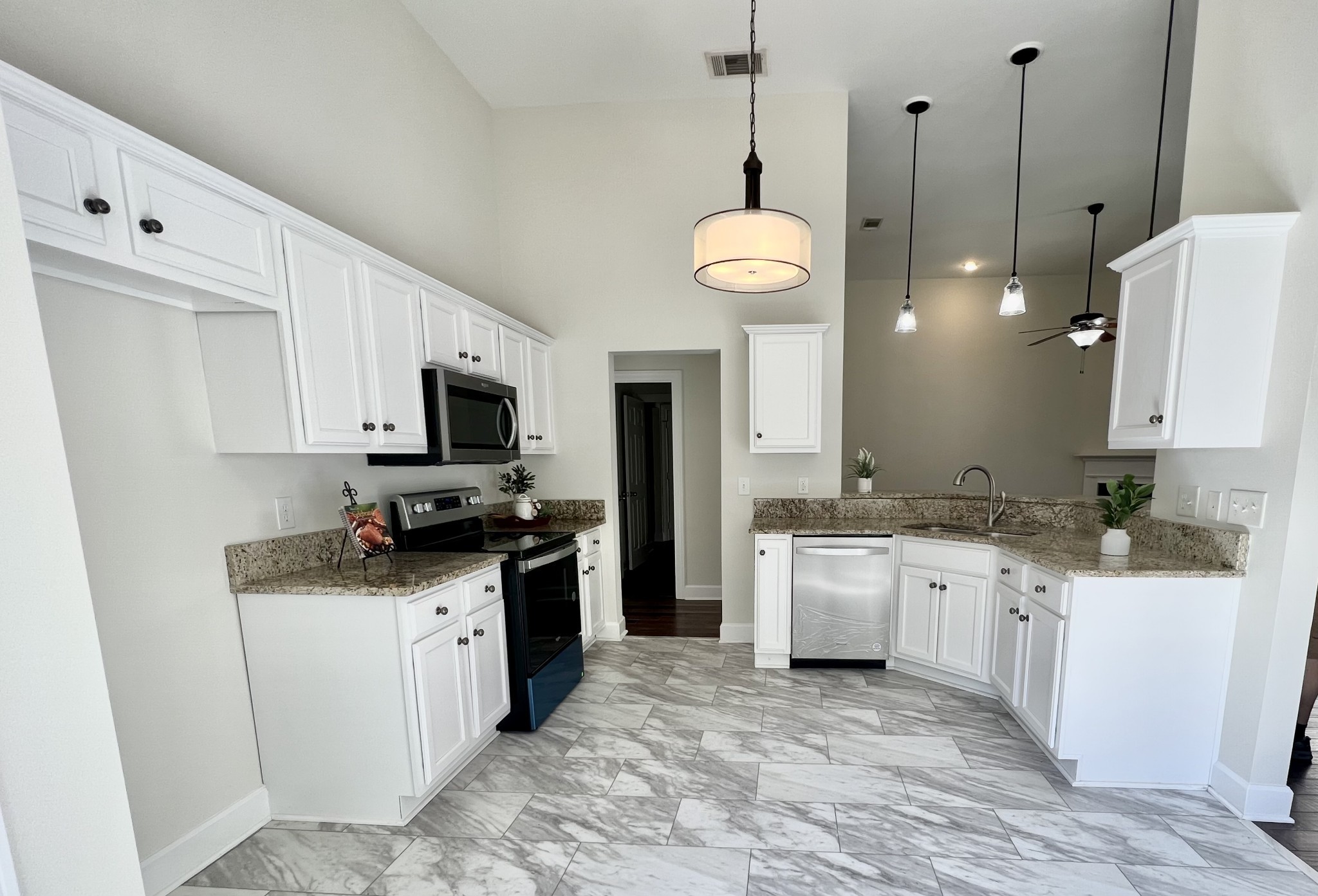 2030 Spring Branch Drive Madison, TN 37115 - Photo 27 of 32 a kitchen with stainless steel appliances granite countertop a sink stove and refrigerator