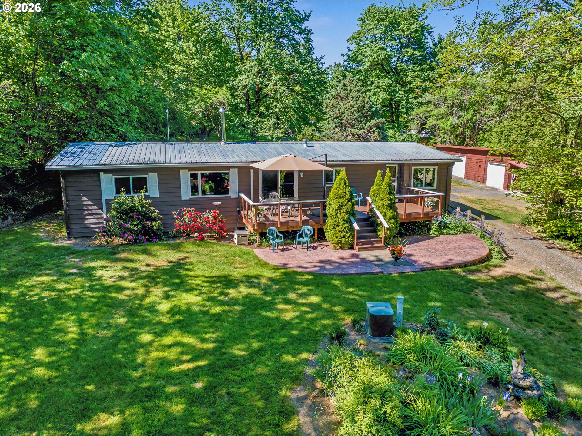 50995 Southeast Baty Road Sandy, OR 97055 - Photo 31 of 47 a view of a house with backyard sitting area and garden