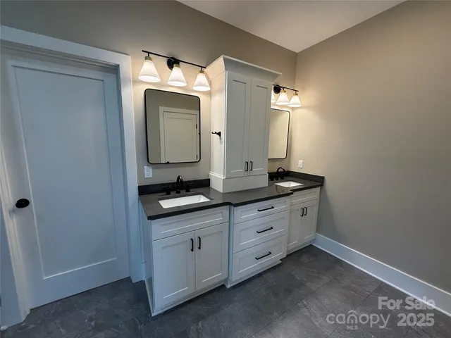 a bathroom with a double vanity sink and a mirror