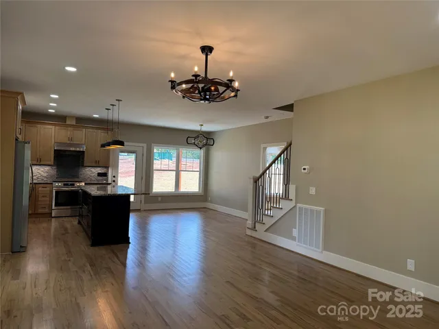 a living room with a couch and a chandelier