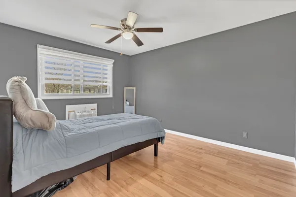 a bedroom with a bed and a window
