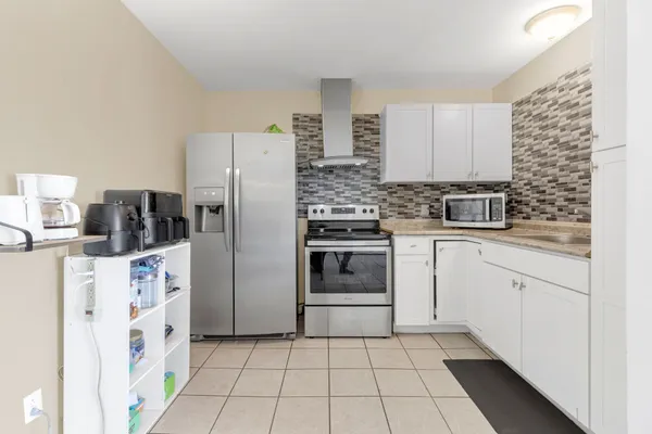 a kitchen with stainless steel appliances a refrigerator sink and cabinets