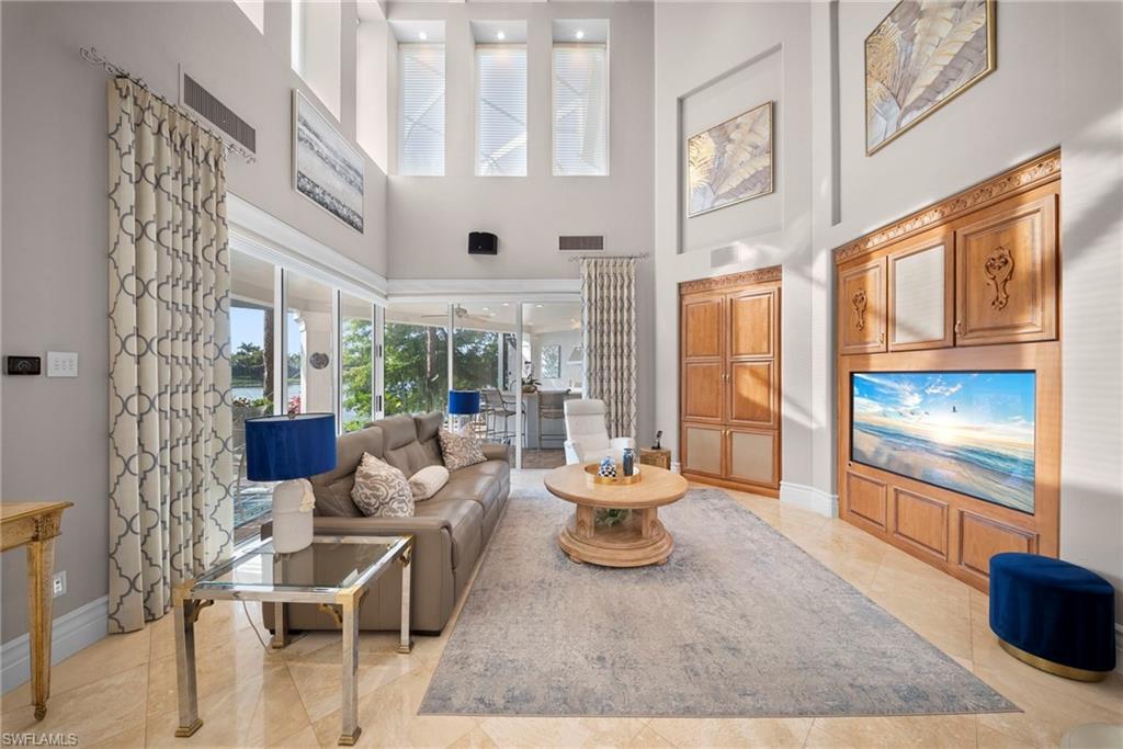 10057 Orchid Ridge Lane Estero, FL 34135 - Photo 11 of 30 a living room with furniture and a floor to ceiling window