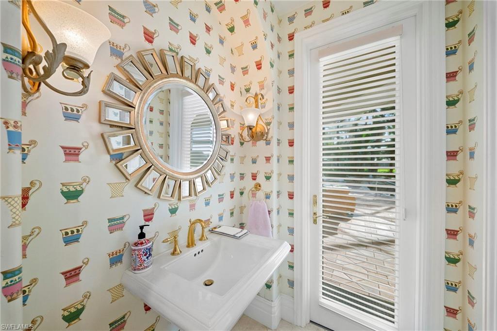 10057 Orchid Ridge Lane Estero, FL 34135 - Photo 14 of 30 a bathroom with a sink a mirror and a shower curtain