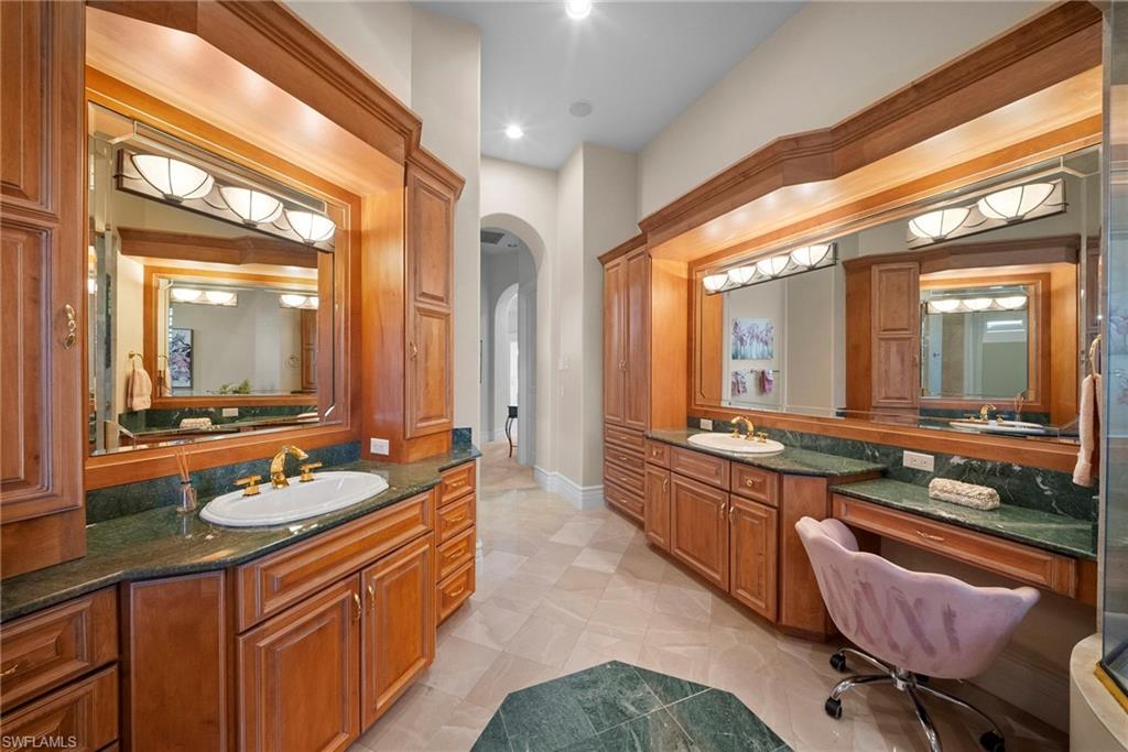 10057 Orchid Ridge Lane Estero, FL 34135 - Photo 18 of 30 a bathroom with a granite countertop sink and a large mirror