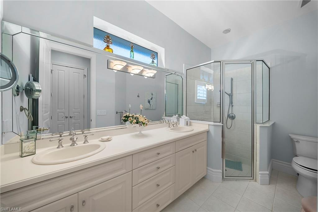 10057 Orchid Ridge Lane Estero, FL 34135 - Photo 24 of 30 a bathroom with a double vanity sink mirror and toilet