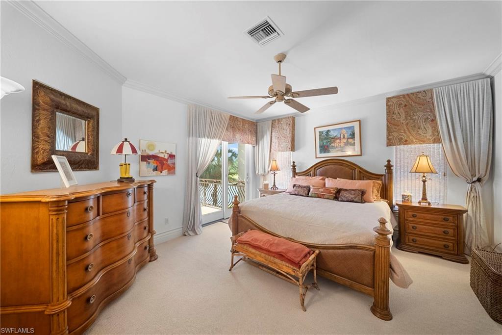 10057 Orchid Ridge Lane Estero, FL 34135 - Photo 26 of 30 a bedroom with a bed and a chandelier