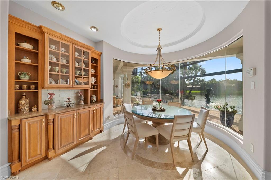 10057 Orchid Ridge Lane Estero, FL 34135 - Photo 7 of 30 a view of a dining room and chandelier fan
