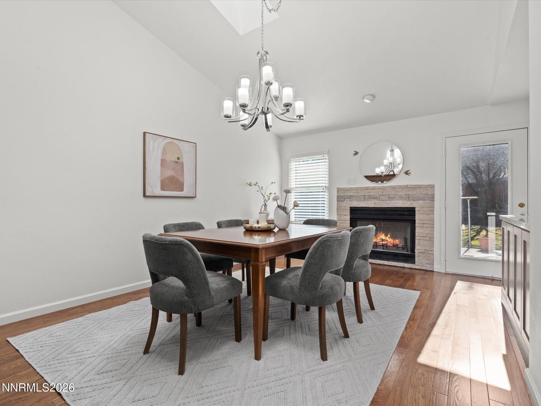 1588 Wheatgrass Drive Reno, NV 89509 - Photo 13 of 42 a view of a dining room with furniture a chandelier and wooden floor