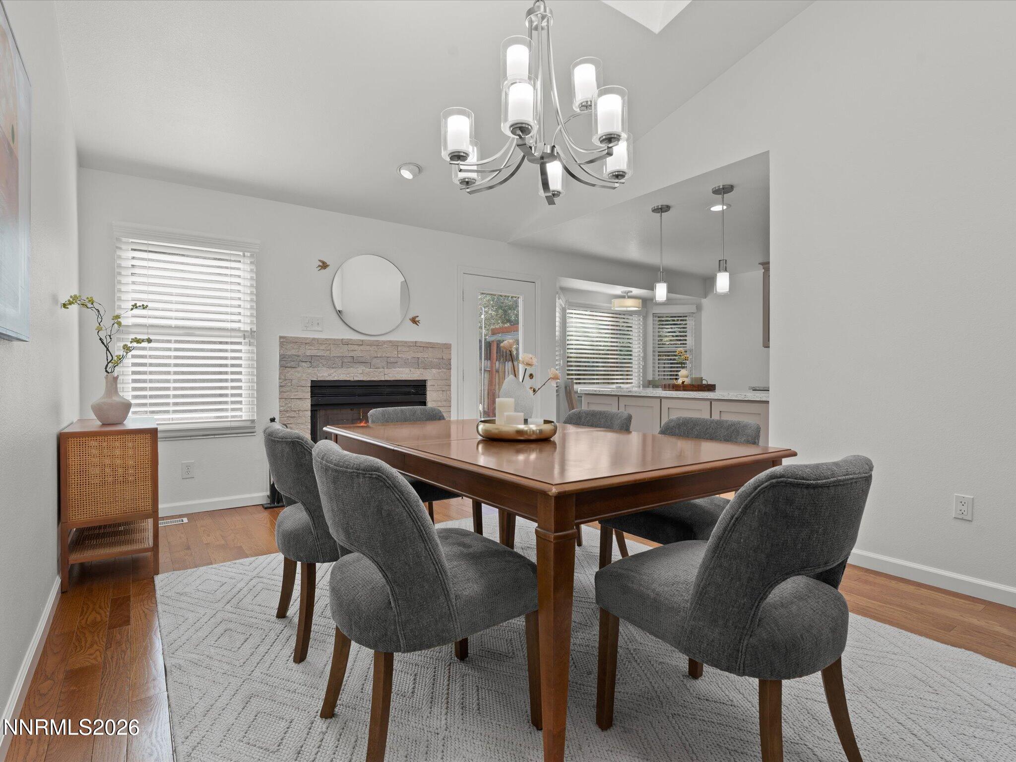 1588 Wheatgrass Drive Reno, NV 89509 - Photo 14 of 42 a view of a dining room with furniture a chandelier and wooden floor