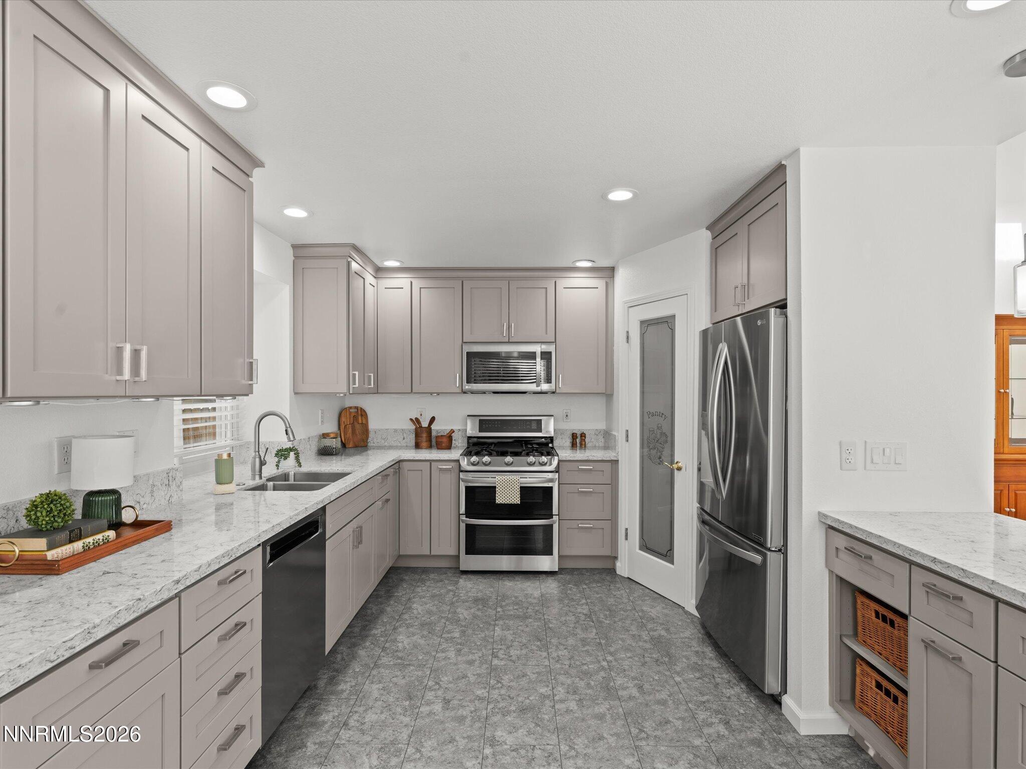 1588 Wheatgrass Drive Reno, NV 89509 - Photo 17 of 42 a kitchen with kitchen island granite countertop a refrigerator stove and sink