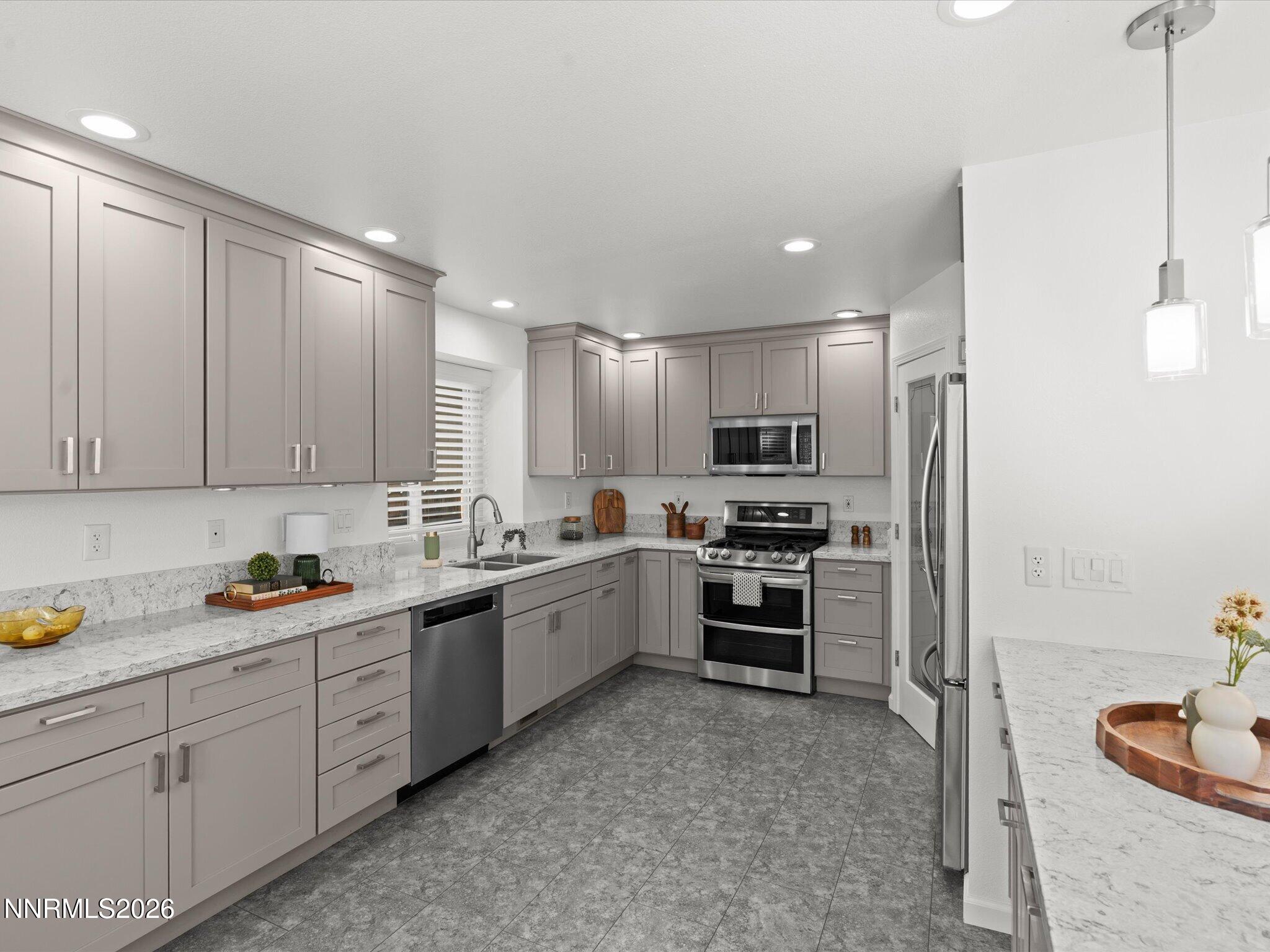 1588 Wheatgrass Drive Reno, NV 89509 - Photo 18 of 42 a kitchen with white cabinets sink and stainless steel appliances