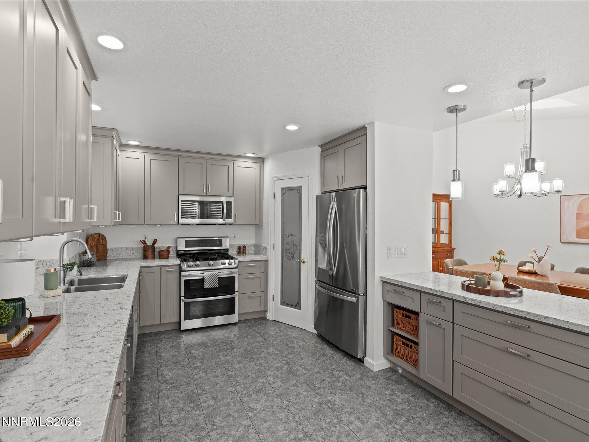 1588 Wheatgrass Drive Reno, NV 89509 - Photo 19 of 42 a kitchen with kitchen island granite countertop stainless steel appliances and refrigerator
