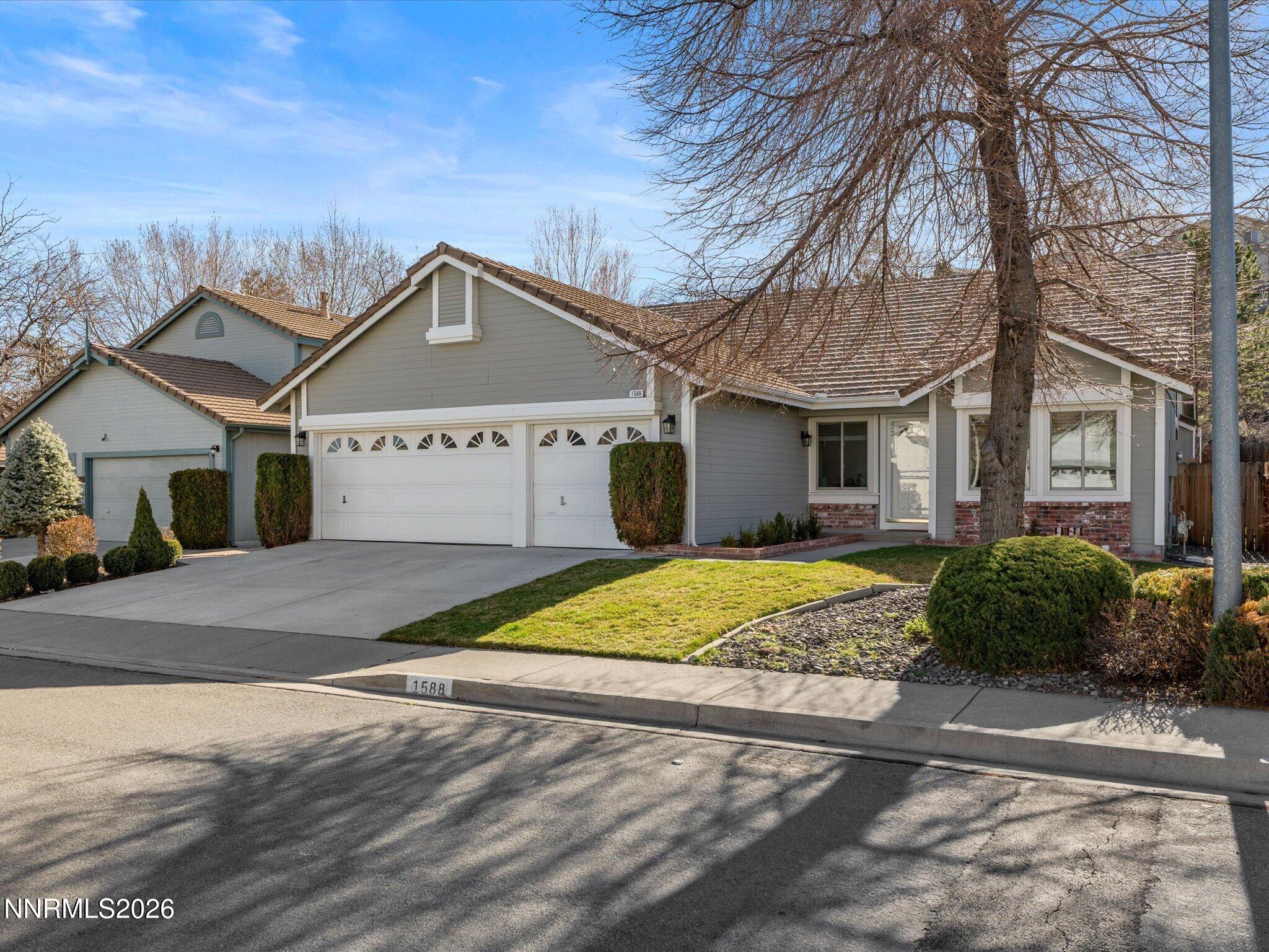 1588 Wheatgrass Drive Reno, NV 89509 - Photo 2 of 42 a front view of a house with a yard and garage