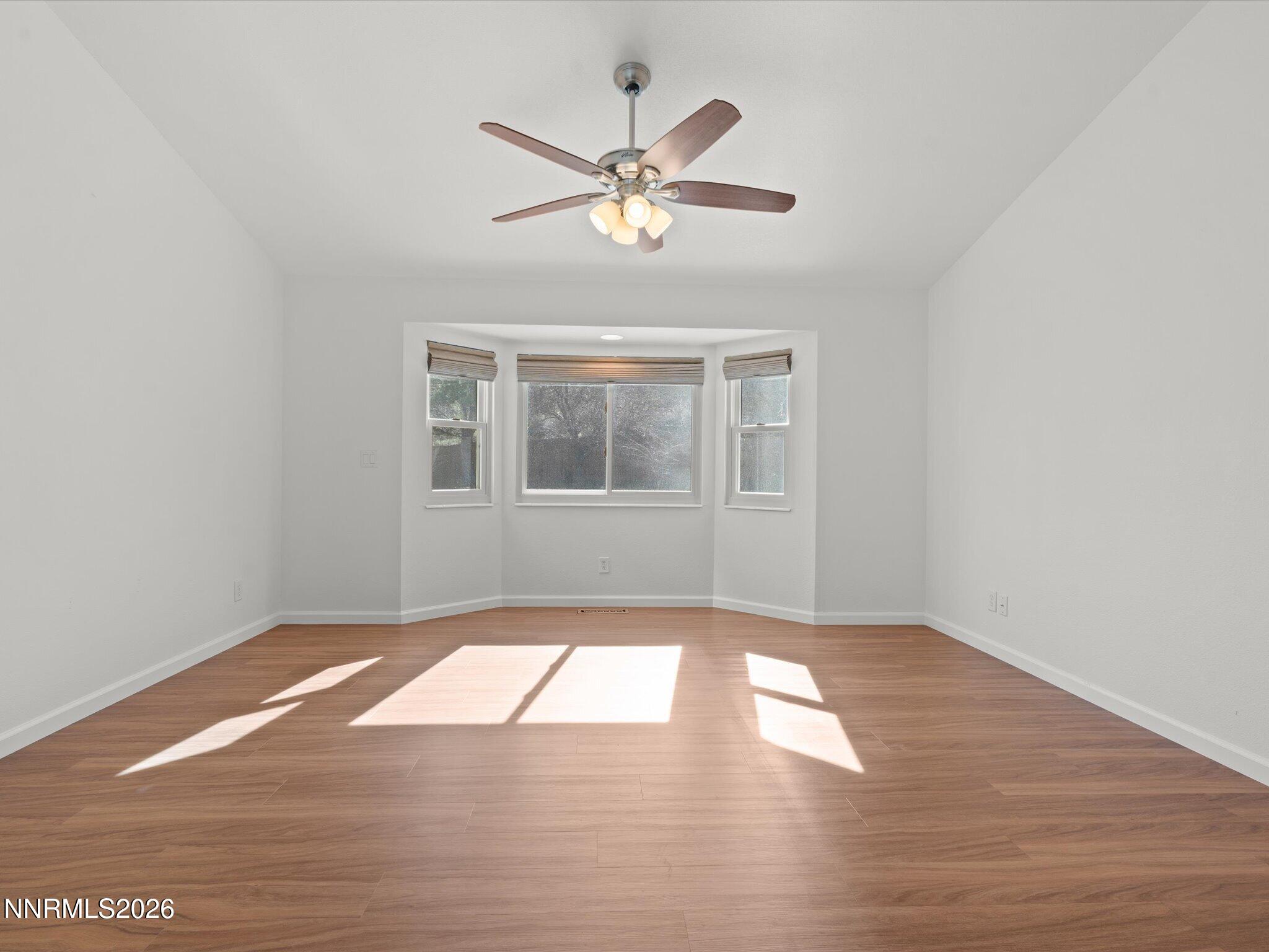 1588 Wheatgrass Drive Reno, NV 89509 - Photo 23 of 42 a view of empty room with wooden floor and fan