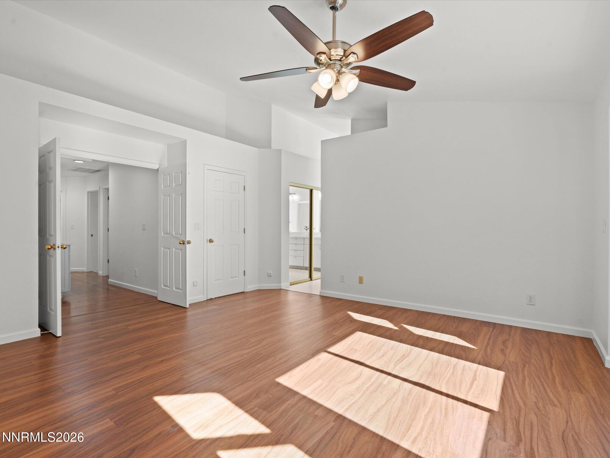 1588 Wheatgrass Drive Reno, NV 89509 - Photo 25 of 42 an empty room with wooden floor and fan