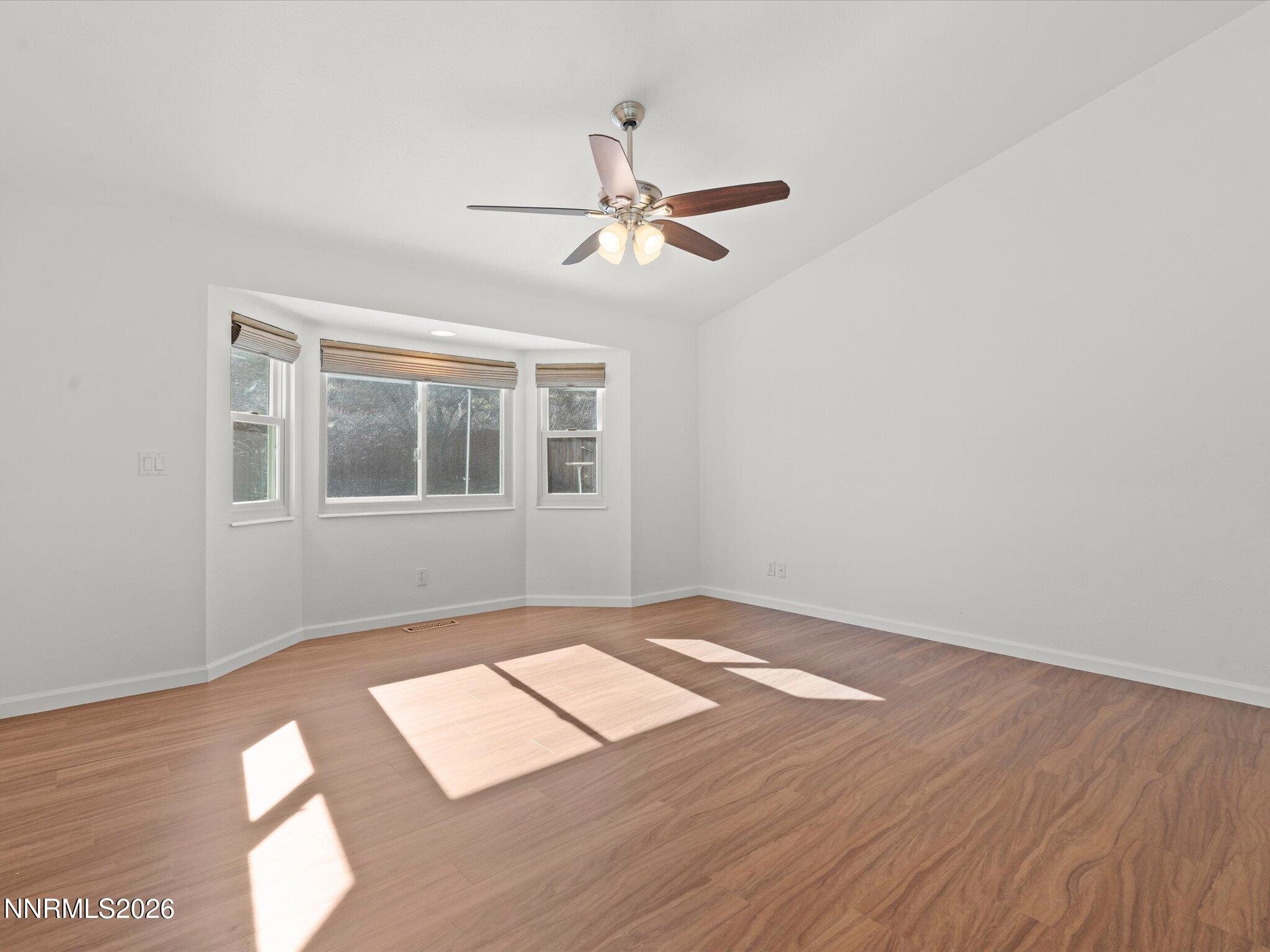 1588 Wheatgrass Drive Reno, NV 89509 - Photo 27 of 42 a view of an empty room with wooden floor and a window