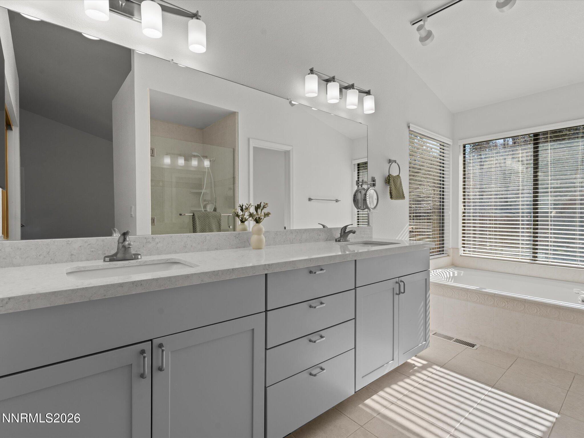 1588 Wheatgrass Drive Reno, NV 89509 - Photo 28 of 42 a bathroom with double vanity and a mirror